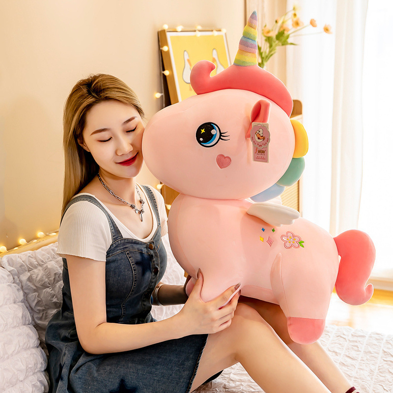 A cute unicorn birthday Christmas present for a girl with a girl with a big toy.
