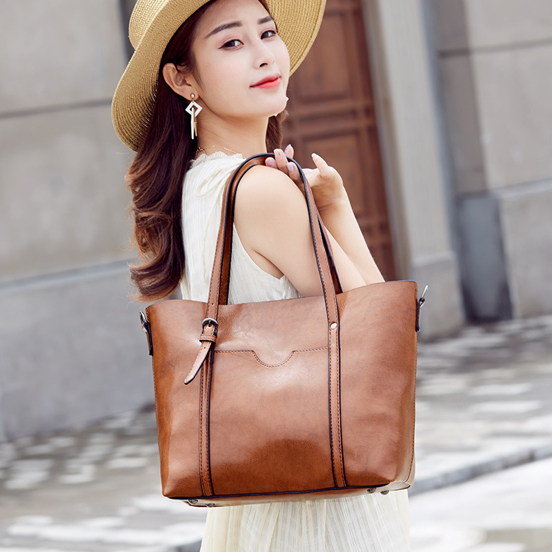 Guangzhou women's bag 2020 new European-American fashion wax skin hand-in-hand, one-shoulder-side cross-blank, large-scale wholesale delivery.