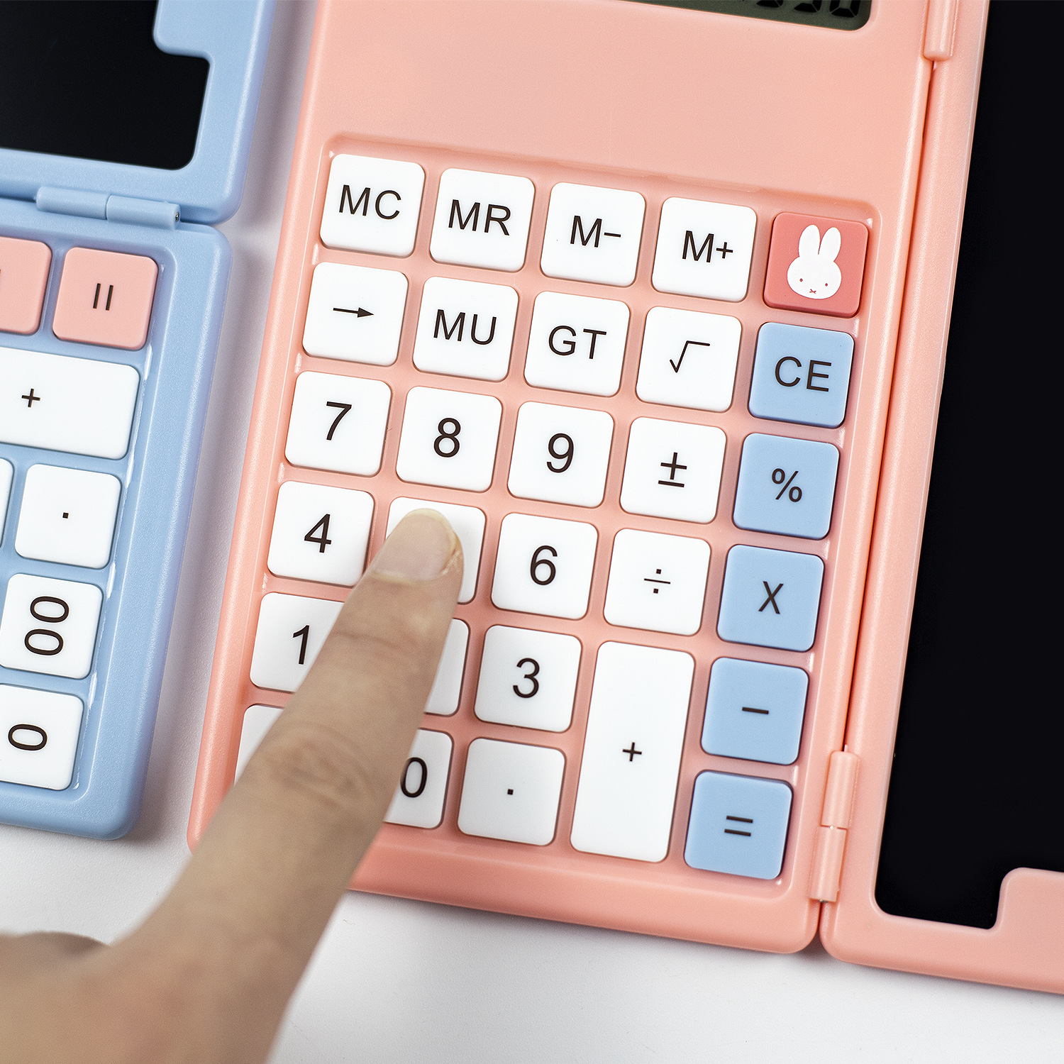 A large, miffy-mife pink child with a hand-written, high-paint calculator board