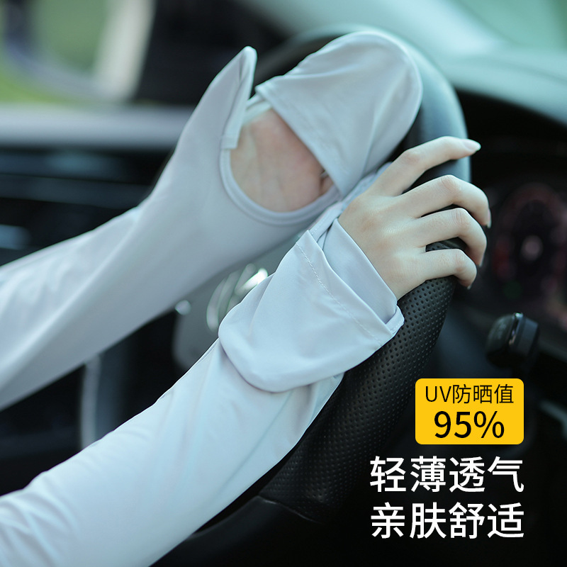 The sun-proof gloves lady rides the electric car outdoors with a long arm cuffs.