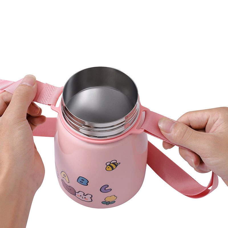 Children tilted across the kettle with a portable bottle of beverage with a mineral bottle card buttoned to the warmer kettle.