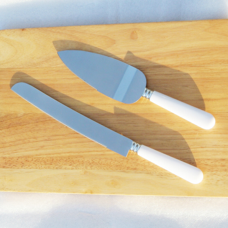 The stainless steel wedding prop, the white-handled cake knife, the bread knife.