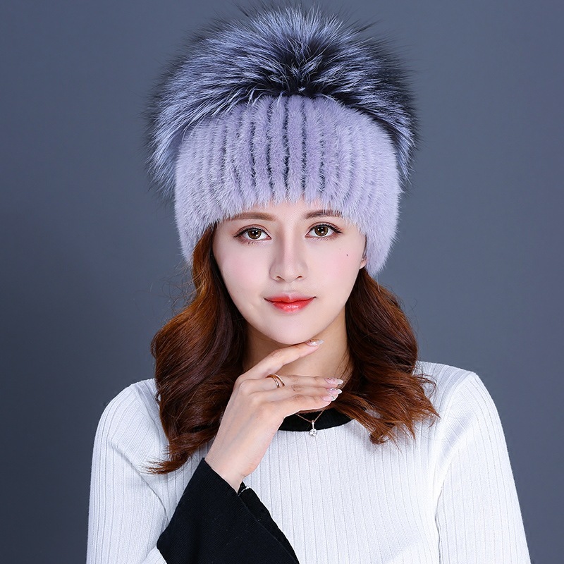 A new woman with a winter fur hat and a mink full of mink hats.
