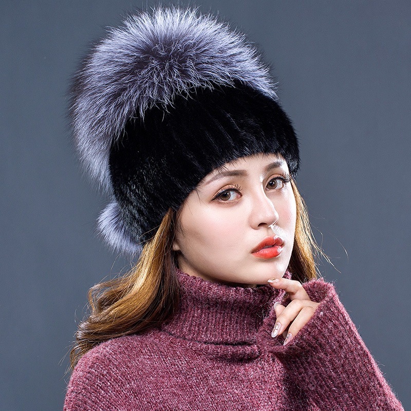 A new woman with a winter fur hat and a mink full of mink hats.