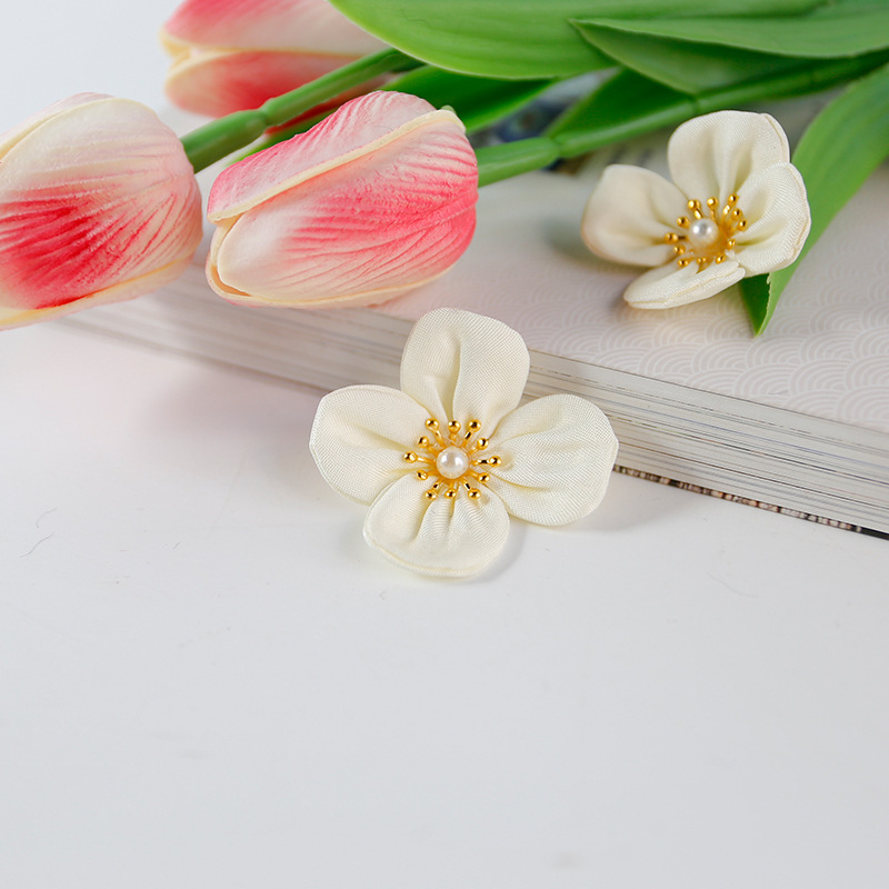 A piece of material for a small flower in a hand-made dialy-finished dress.