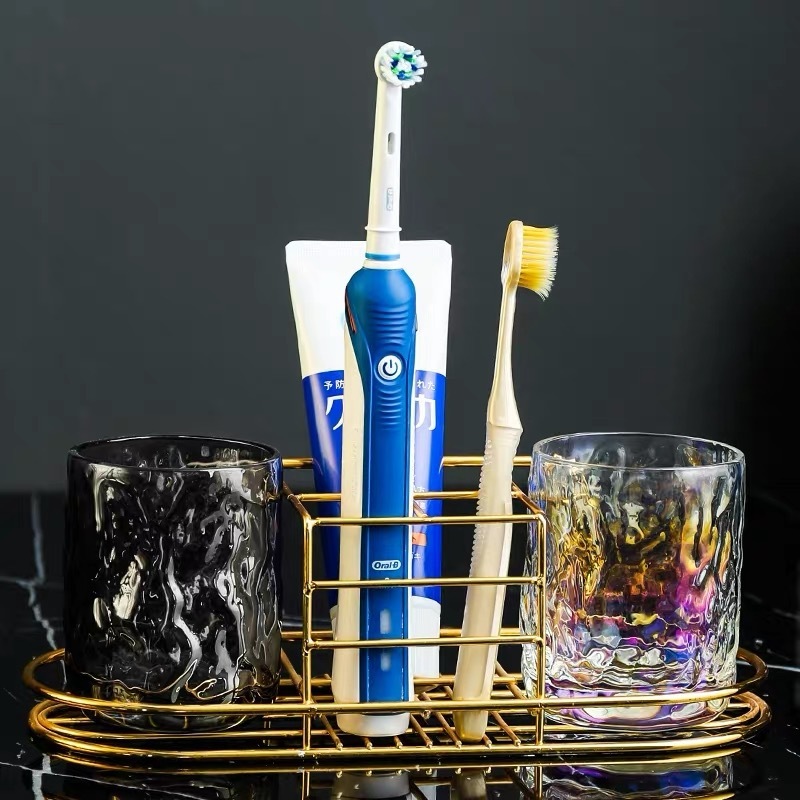 A wall-mounted stand with a toothbrush and a toothbrush and a toothbrush set in the bathroom