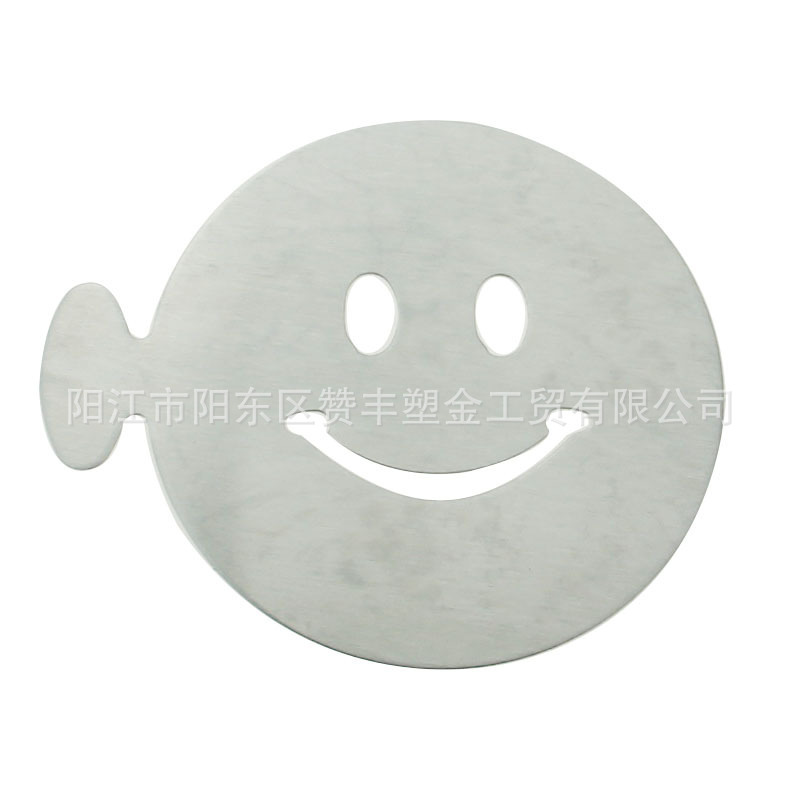Multiple stainless steel-based coffee molds, six pairs of smiling faces on the cocoa-spray template.