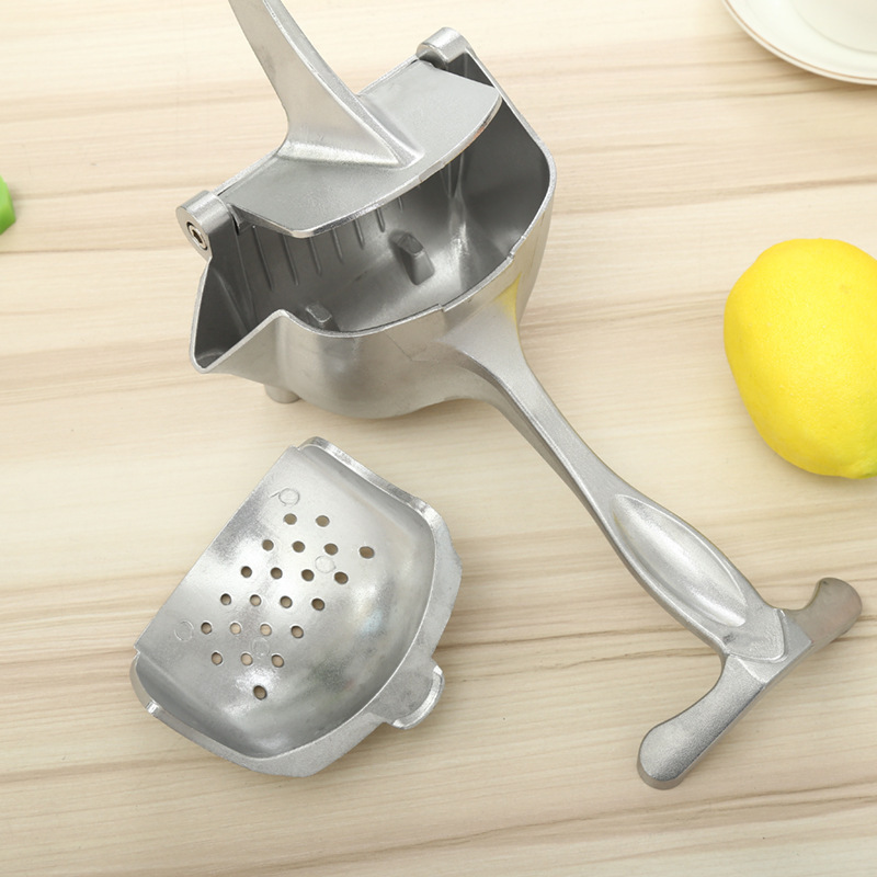 Hand-held Juicer sets up a commercial home with a lemon Juicer and a fruit-crusher with a spot of orange.