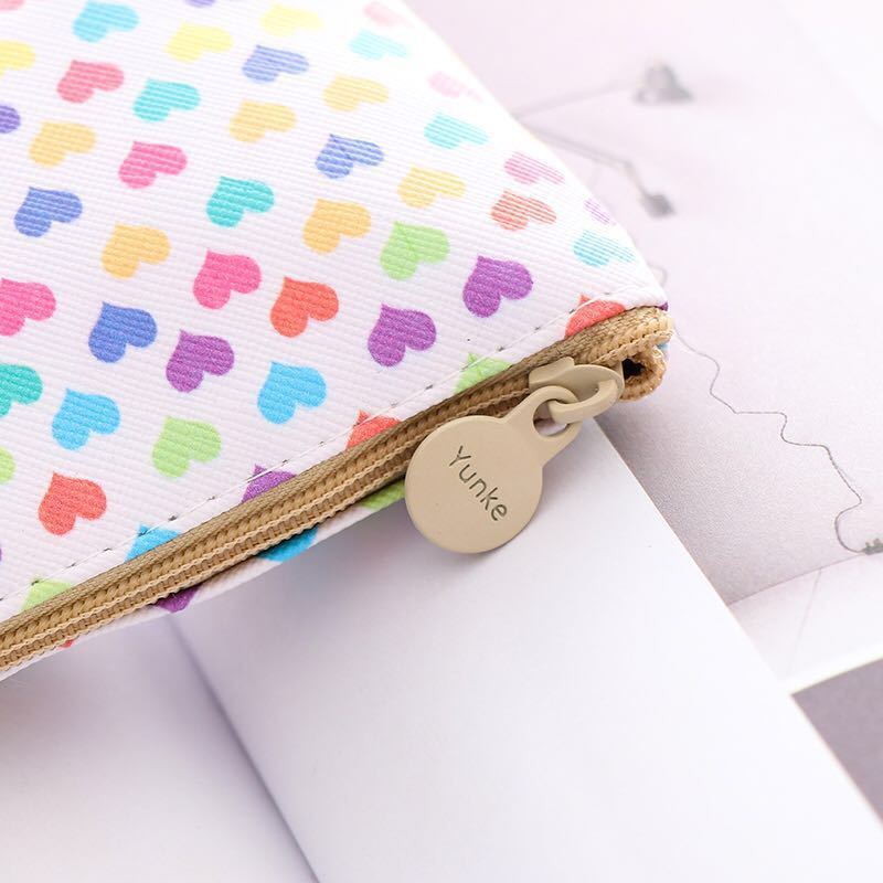 A young girl with a leather-brained unicorn pen bag for schoolgirls.