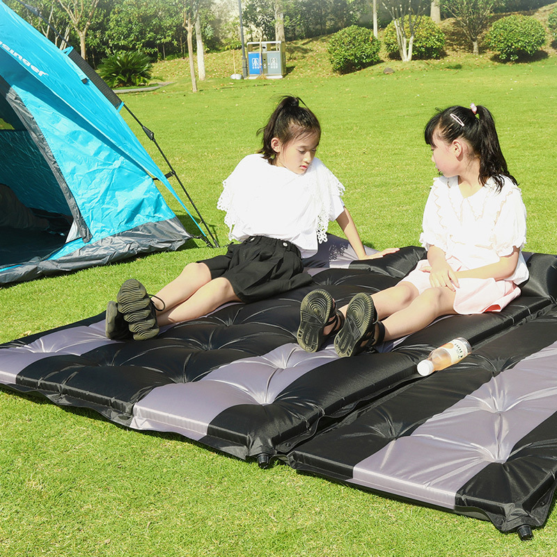 An auto-inflated outdoors tent sleeps on a mattress with a tidal pad and a camping mattress.