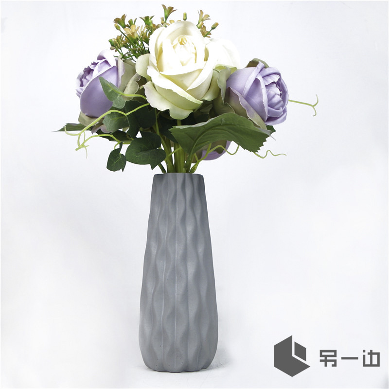 The other side of the concrete vase, the dry bouquet, the home door, the ornamental gift.