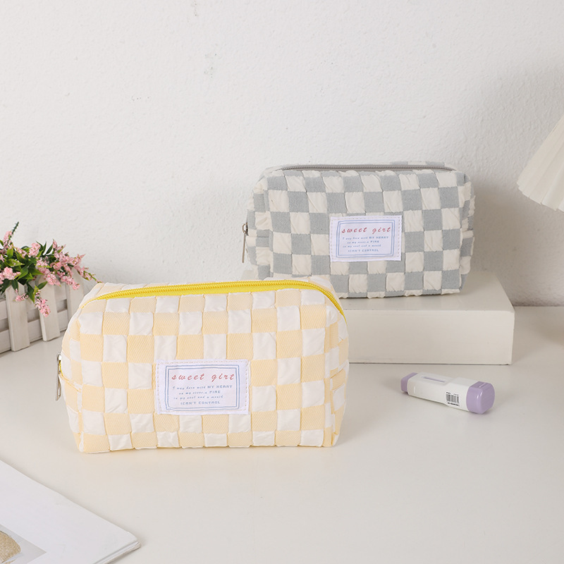 A little candy-coloured new pen bag, a little girls' make-up bag, and a little schoolboy's stationery bag.