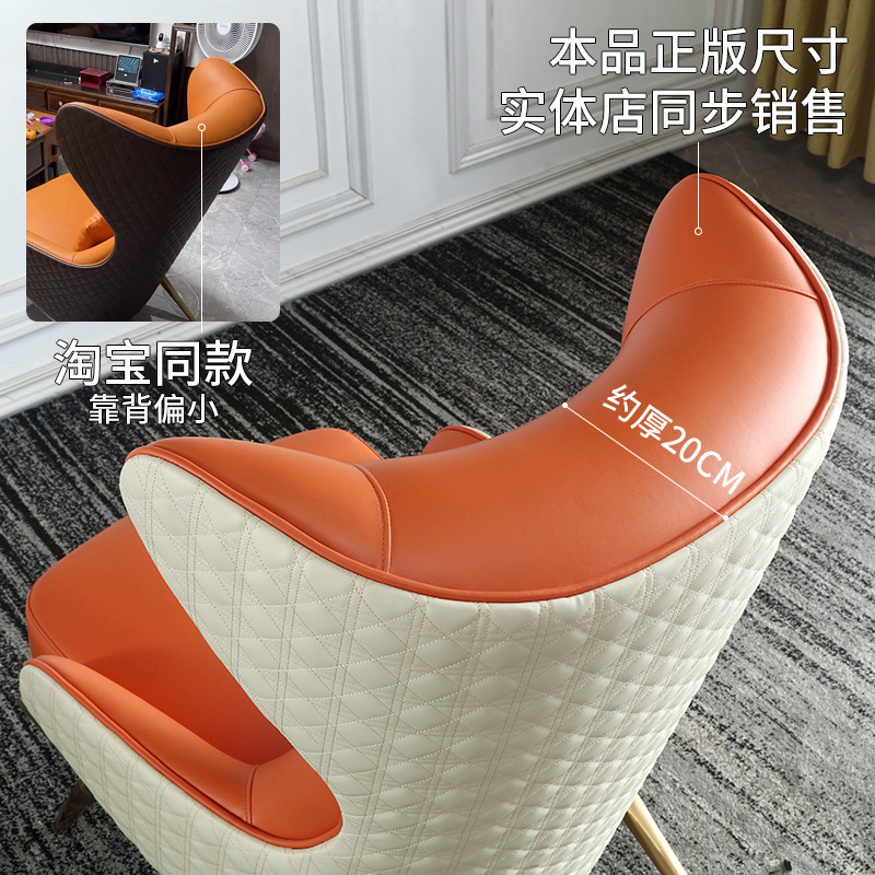 The modern simplistic one-on-one with a high-back couch chair, a tiger chair in the living room of the Leather Designer.