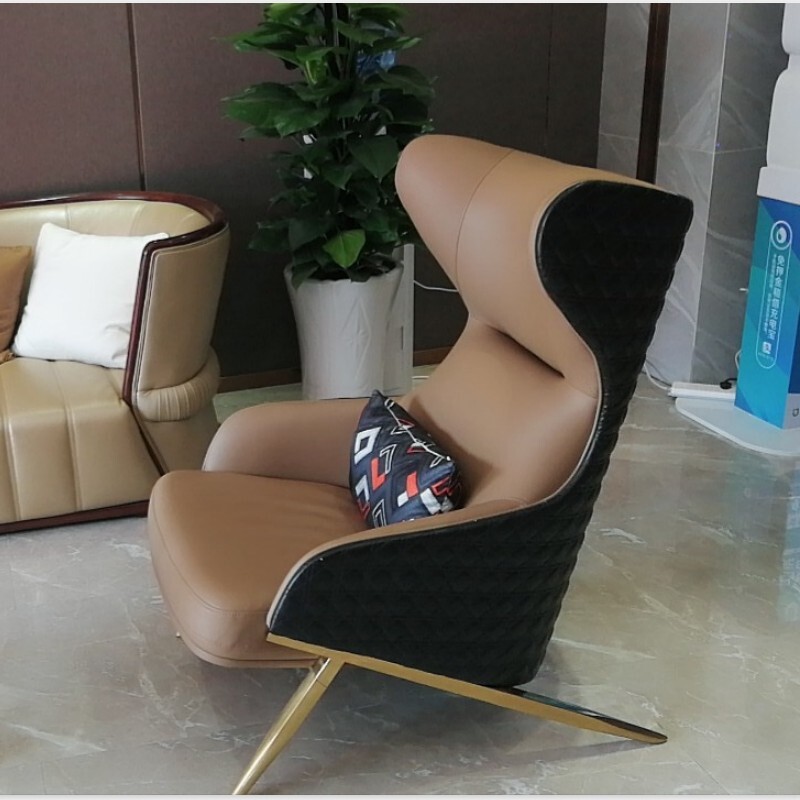 The modern simplistic one-on-one with a high-back couch chair, a tiger chair in the living room of the Leather Designer.