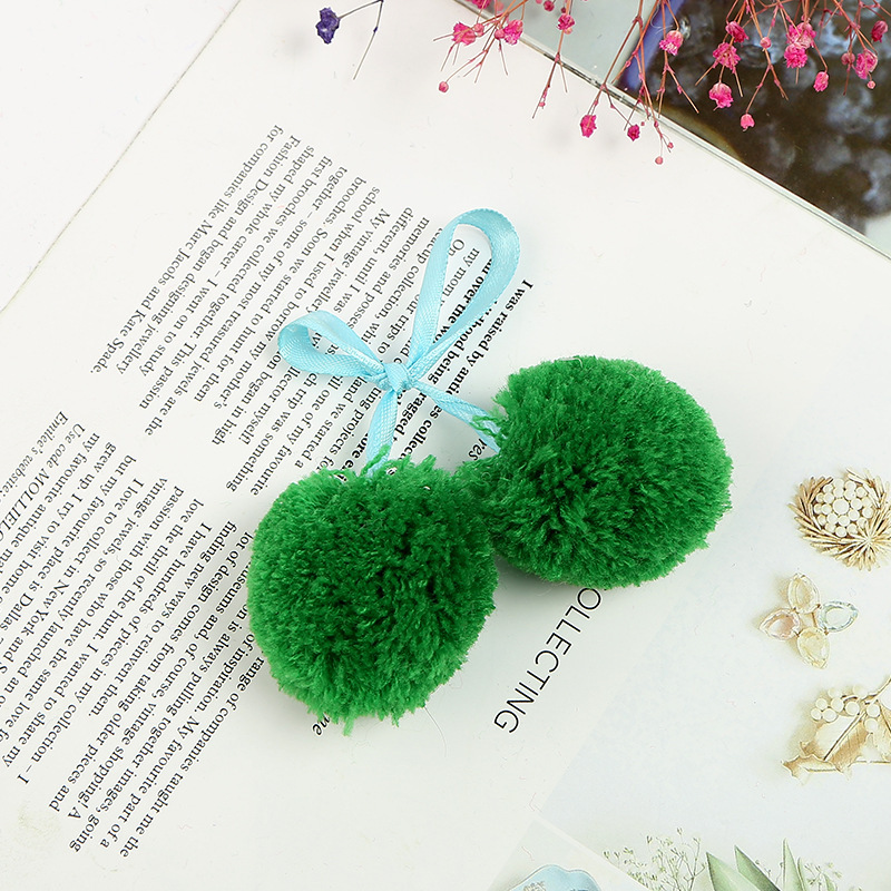 The spot green ribbon is wholesaled to a handmade cashmere factory with four centimetres of barley balls.