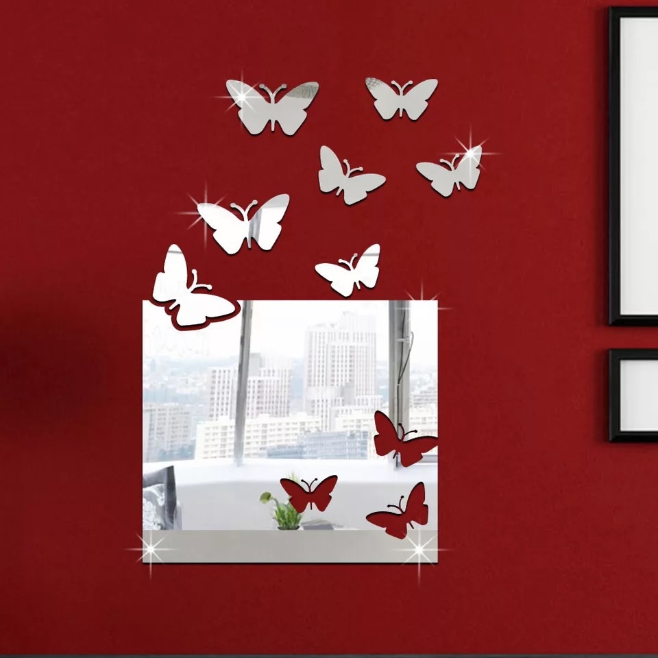 A mirror wall with a large box of butterflies on the wall of the living room.