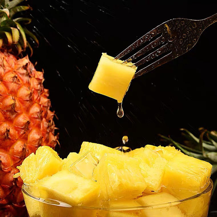 A box full of pineapple-sweet fruit hand torn out of the pineapple and juicy pineapple.