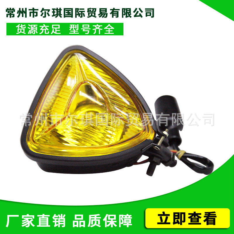 Old schoolhari motorcycle retrofitted triangular metal-glass frontlights approaching light fittings