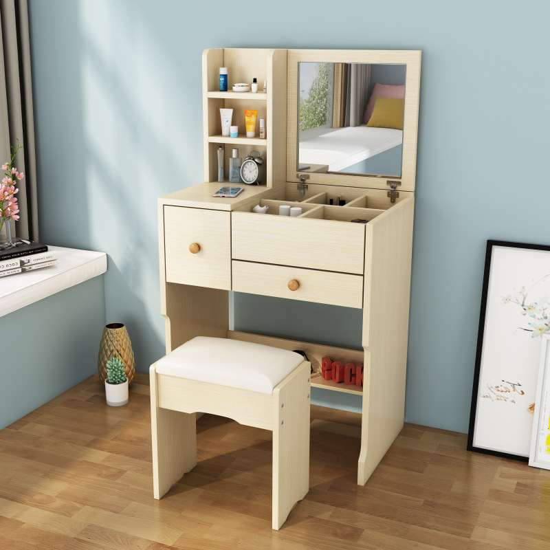 A small-room bedroom with a simple, capped-up dresser.