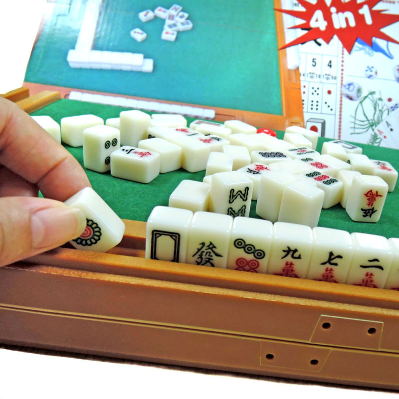 A customized mini mahjong with a folding table engraved trip with a dice on the cardboard.