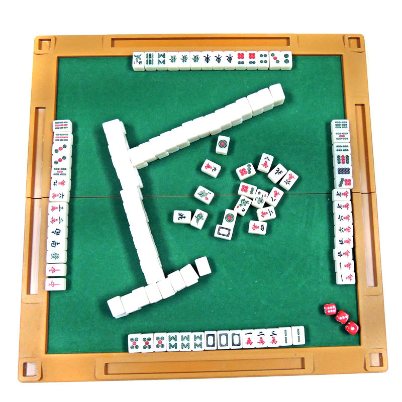 A customized mini mahjong with a folding table engraved trip with a dice on the cardboard.