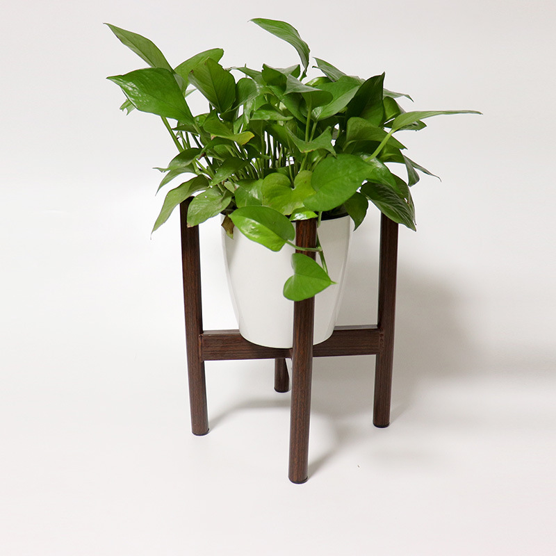 A small steel shelf with an iron glass bottle on the bottom of the vase.