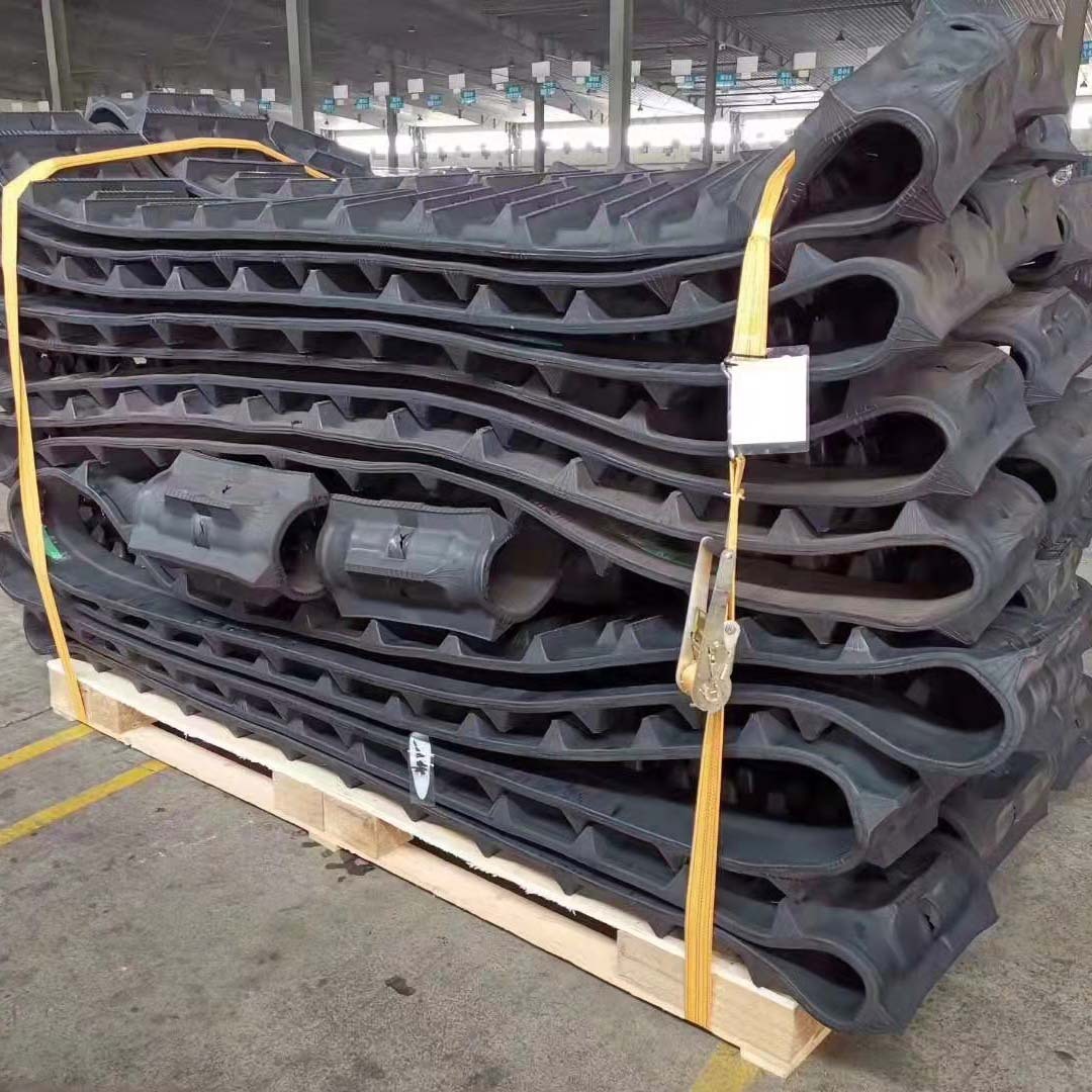 A small tiller climbs a chain of tigers, a belt wheel, an excavator ticking a whole terrain rubber belt.