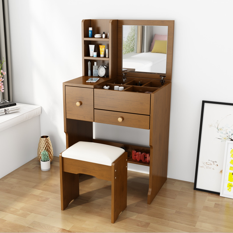 A small-room bedroom with a simple, capped-up dresser.