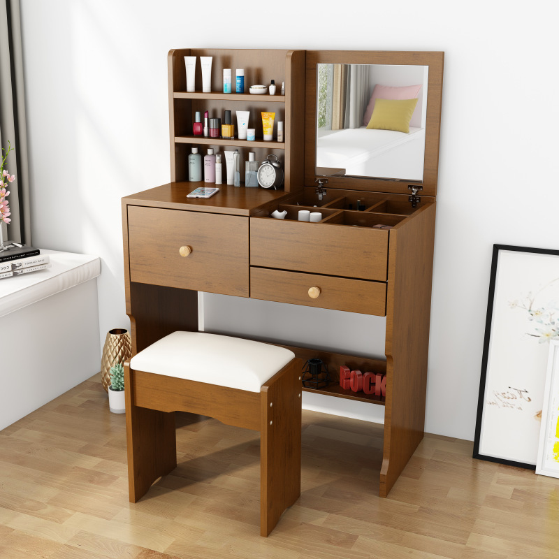 A small-room bedroom with a simple, capped-up dresser.