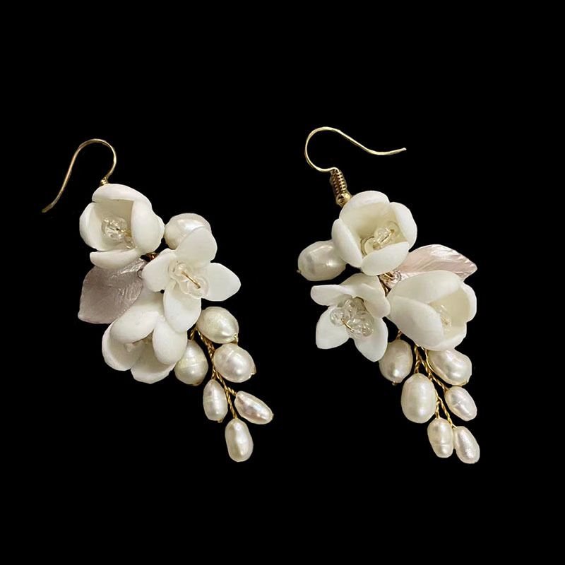 You've crossed the border for the European-American wedding bride's earring, white ceramics, and fresh water pearls.