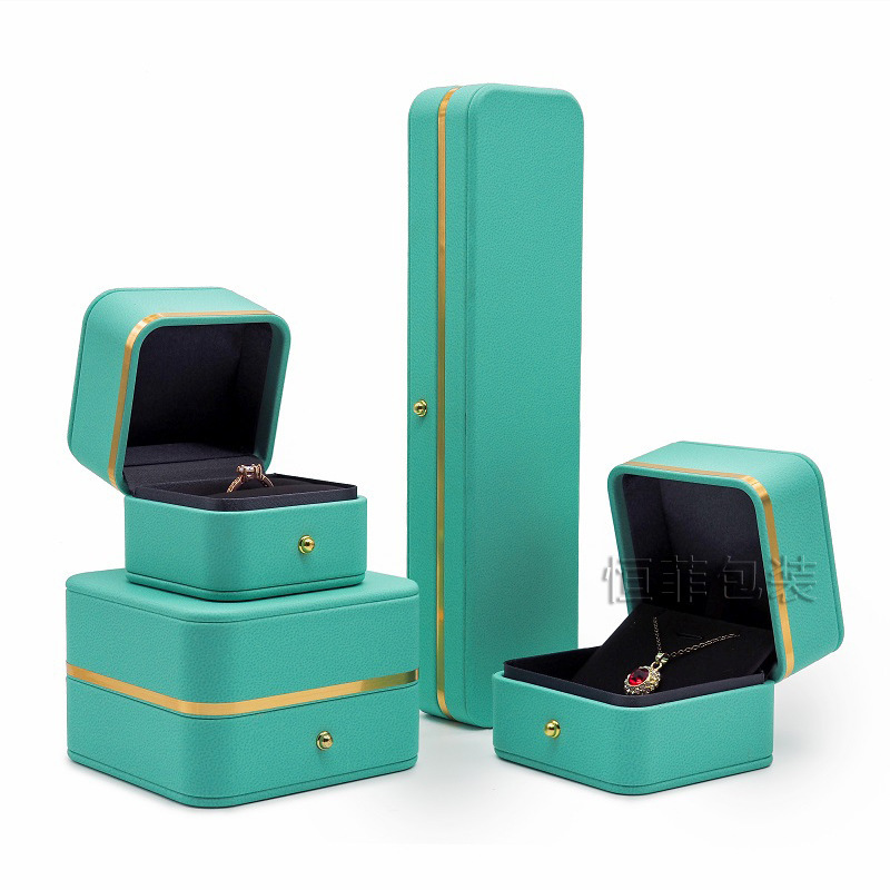 A large jewelry box with a pup-covered ring box with a bracelet box with a gold-side jewelry box.