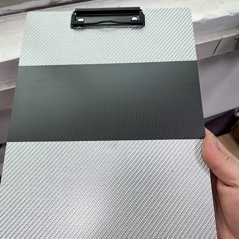 Carbon fibreboard with A5 office documents and a black-stamped hard and simple business meeting A4 folder