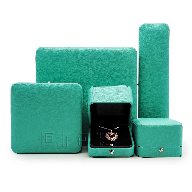 A new, light green corner PU box for the ring for the wedding ring.