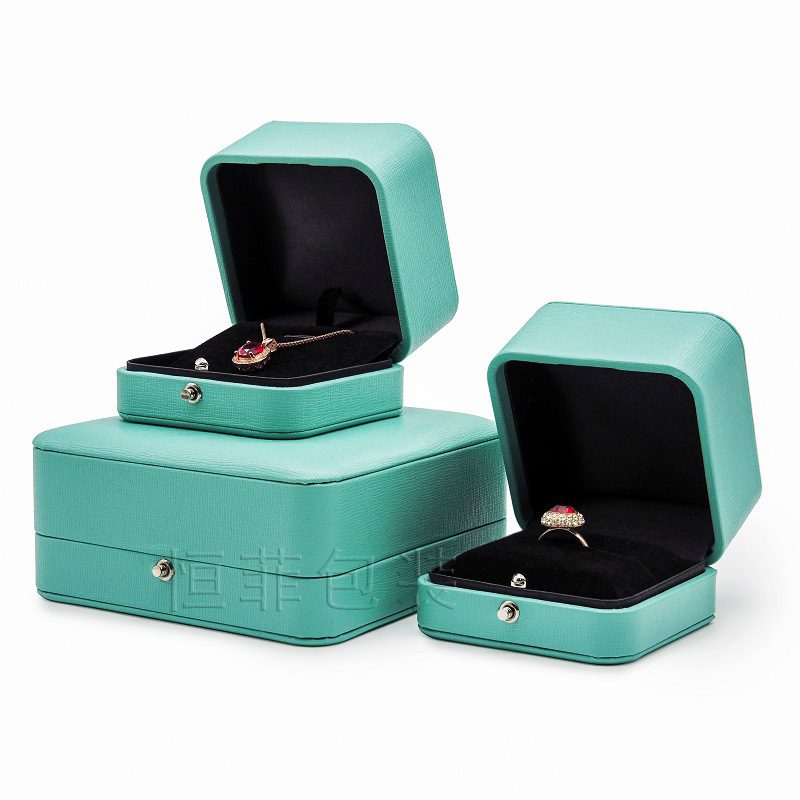 A new, light green corner PU box for the ring for the wedding ring.