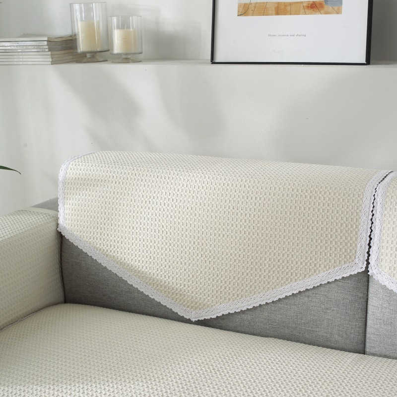 A modern, four-season, generic smooth-slided couch covers, full of towels.