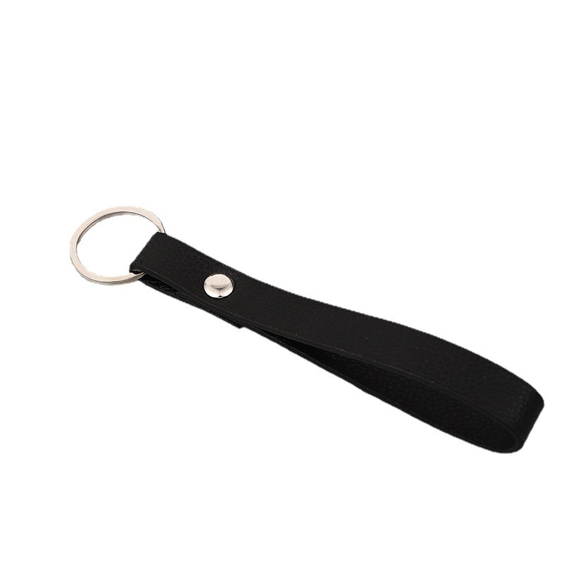 A gift car key button, a leash ring, a black twirl-ed leather key.