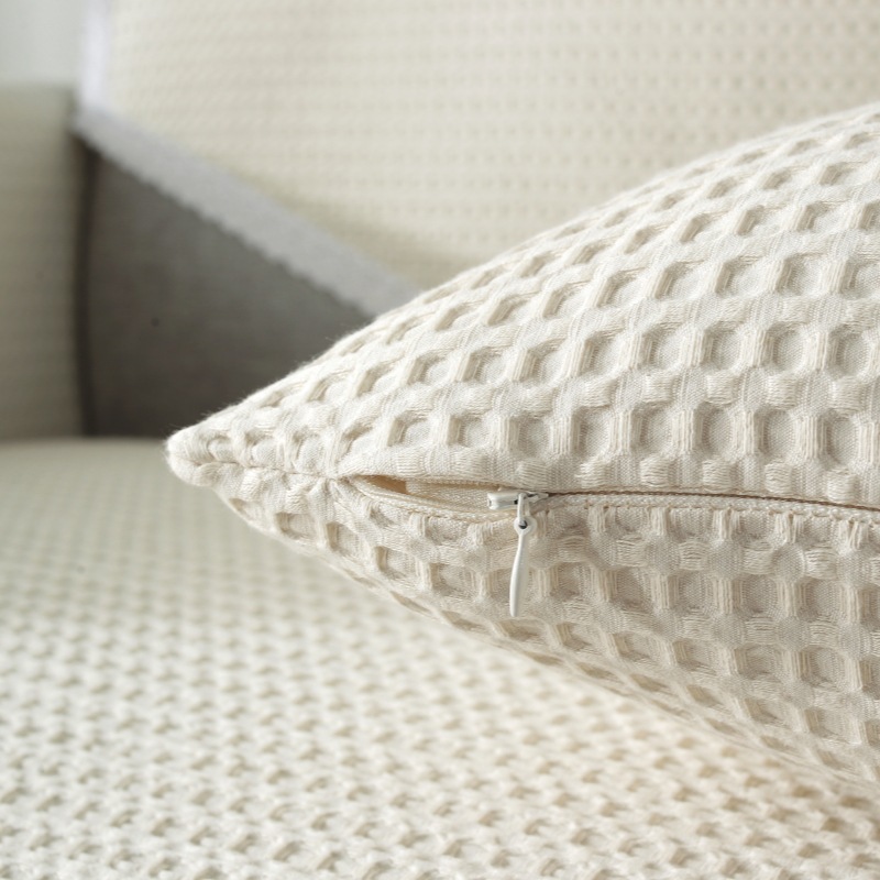 A modern, four-season, generic smooth-slided couch covers, full of towels.