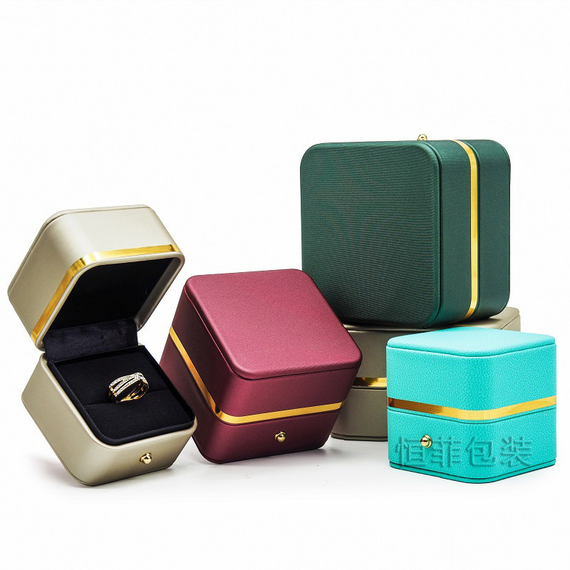 A large jewelry box with a pup-covered ring box with a bracelet box with a gold-side jewelry box.