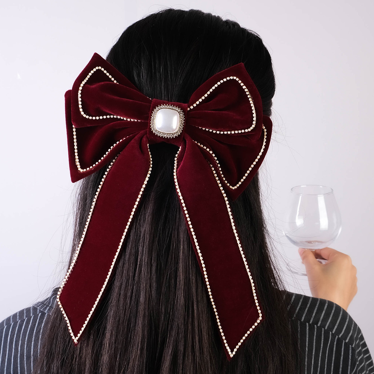 A big red butterfly with red velvet on the top, leading the way to the back of the girl's head.