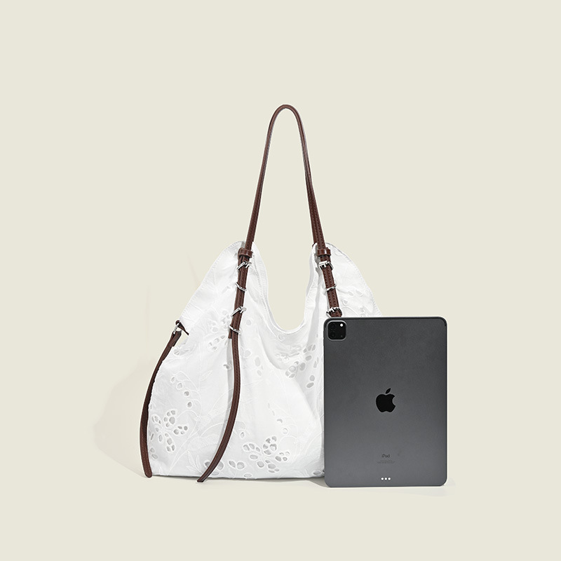 White large-capacity hand-carrying bag for a summer light and light commuter trip.