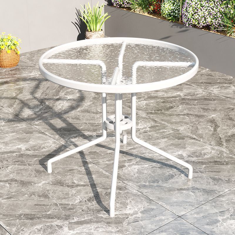 Outside steel glass table, white folding round table, two chairs on the table and tea table.