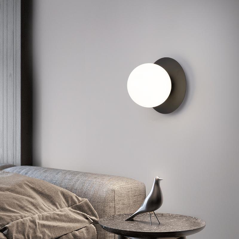 A very simple, round glass corridor walllight at the end of the stairs.