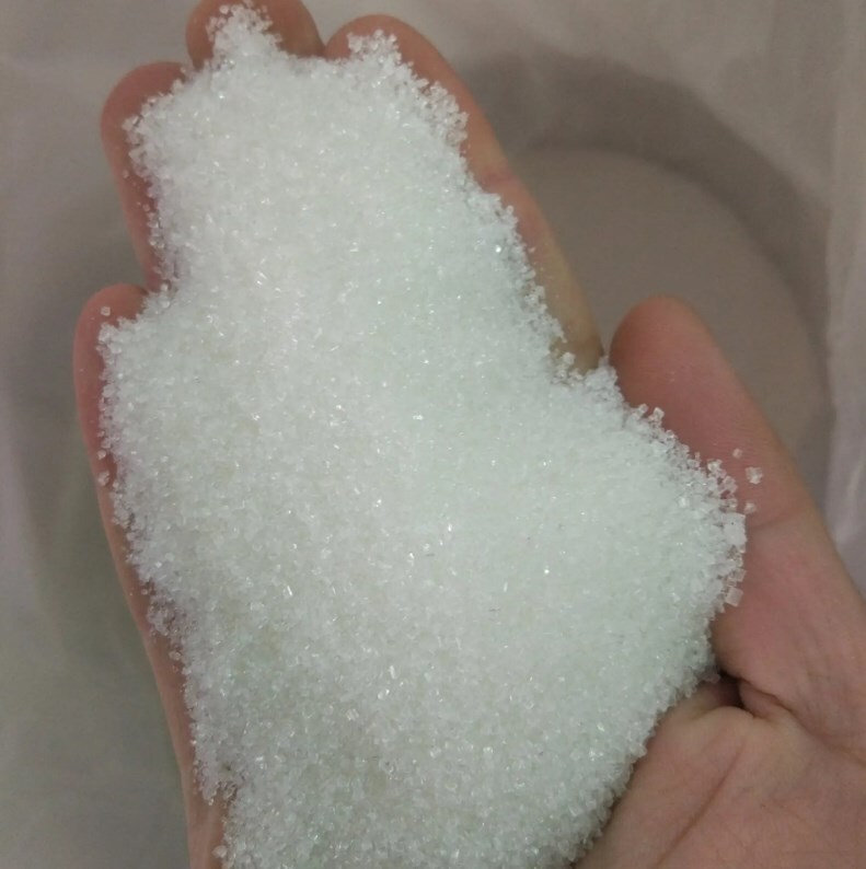 A large bag of white sugar in bulk with sugar powdered food in a white bakery.