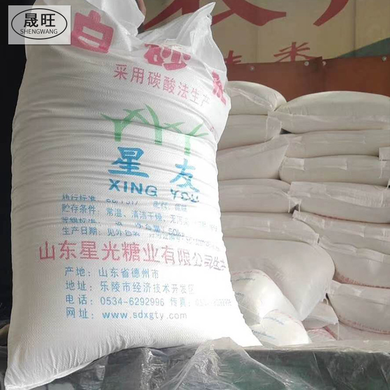 A large bag of white sugar in bulk with sugar powdered food in a white bakery.