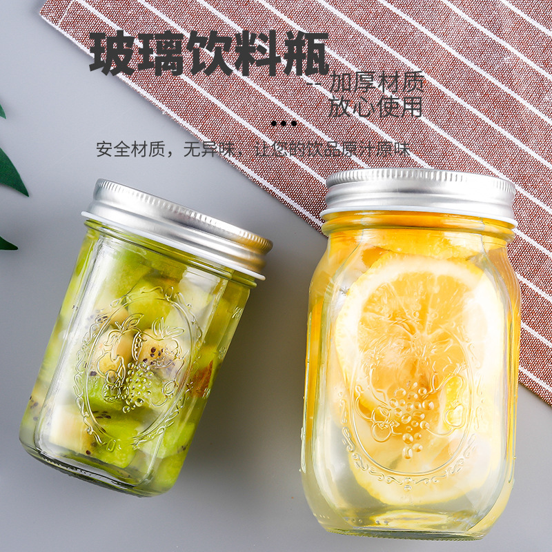 A 16oz wide-cut Mason jar with a straw and a Mason jar with a cold-food jar.