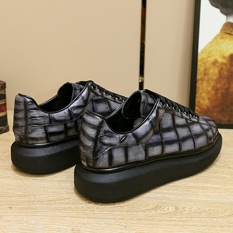 A man with one shoe and a single gator's belly in a oxen-skin McQueen.