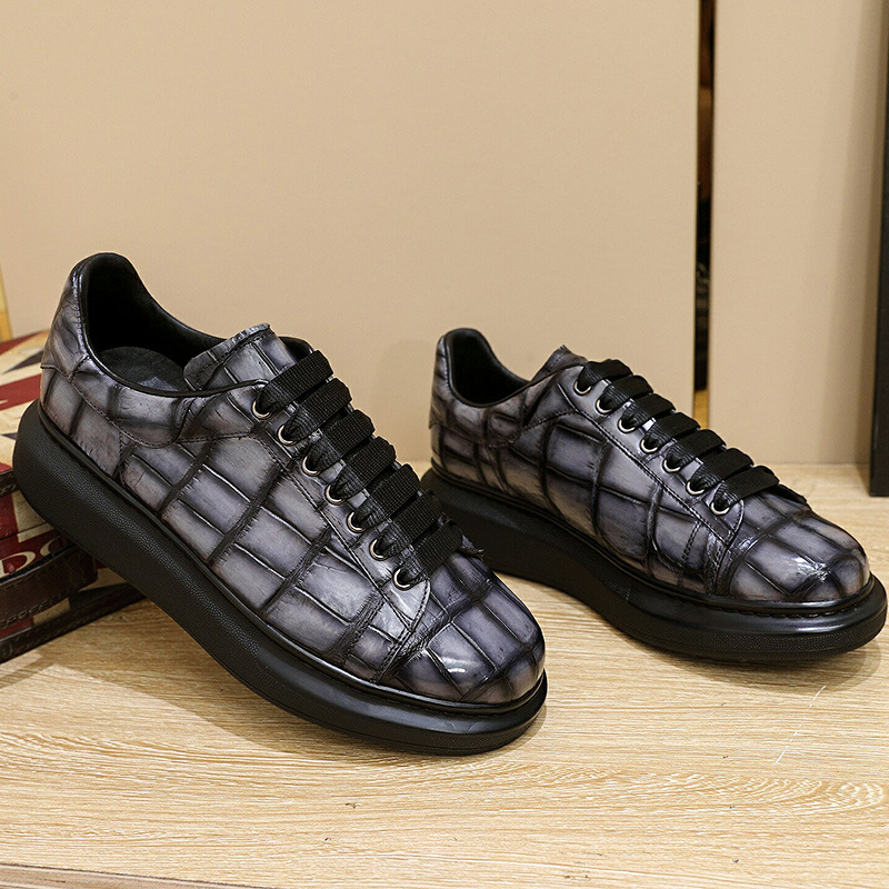 A man with one shoe and a single gator's belly in a oxen-skin McQueen.
