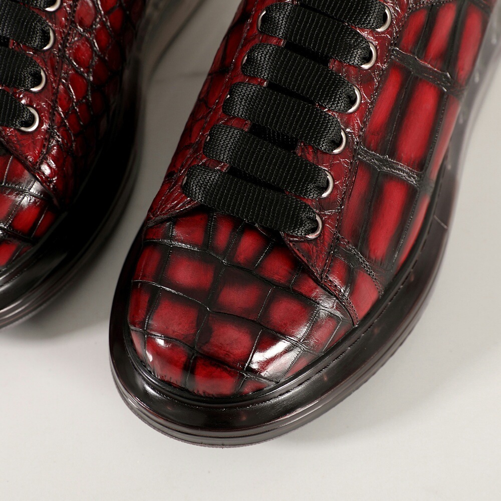 A man with one shoe and a single gator's belly in a oxen-skin McQueen.
