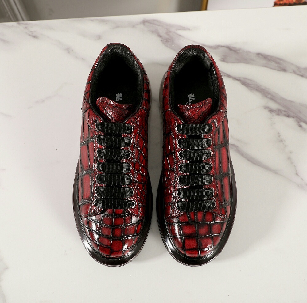 A man with one shoe and a single gator's belly in a oxen-skin McQueen.