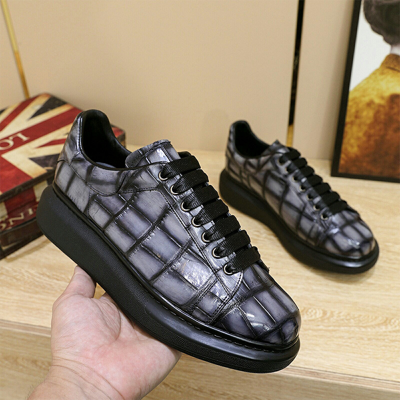A man with one shoe and a single gator's belly in a oxen-skin McQueen.